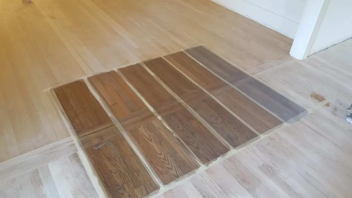 A floor with many different colors of wood.