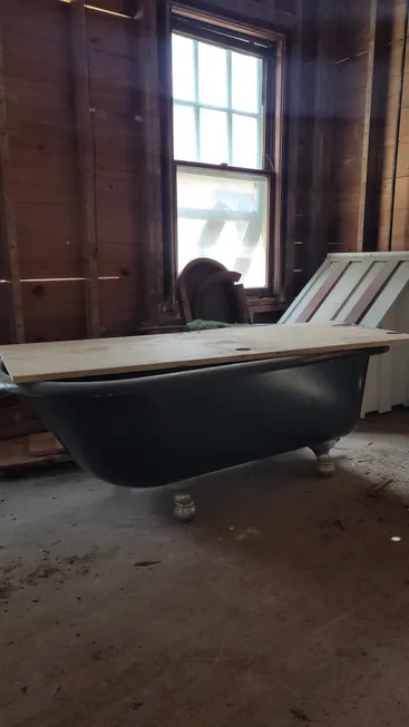 A bathtub sitting in the middle of a room.