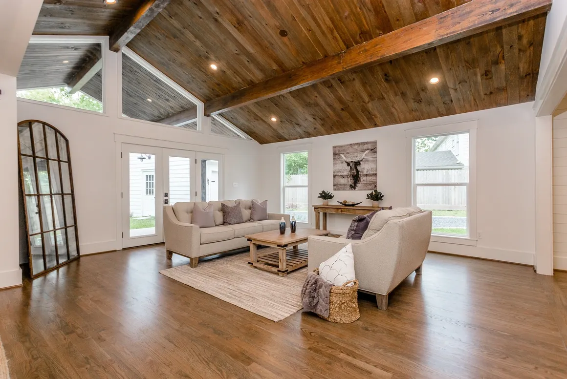 A living room with wood floors and white walls.